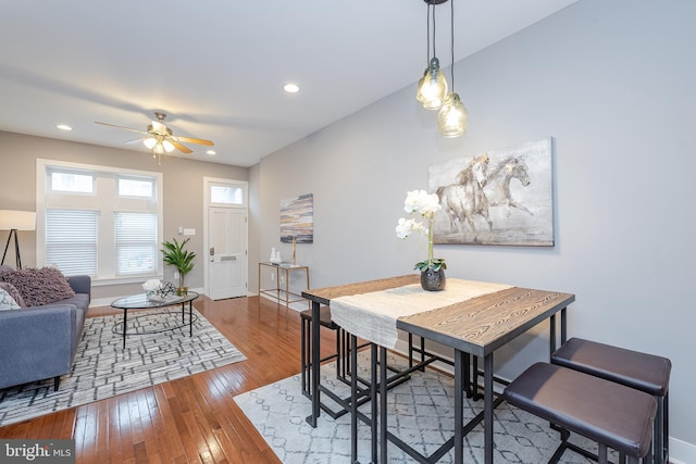 dining room featuring a ceiling fan, recessed lighting, baseboards, and wood finished floors