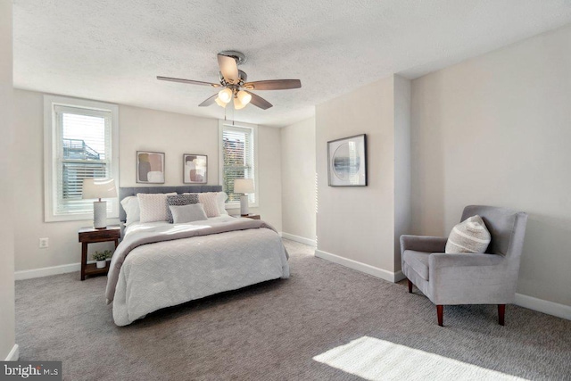 bedroom featuring light carpet, a ceiling fan, baseboards, and a textured ceiling