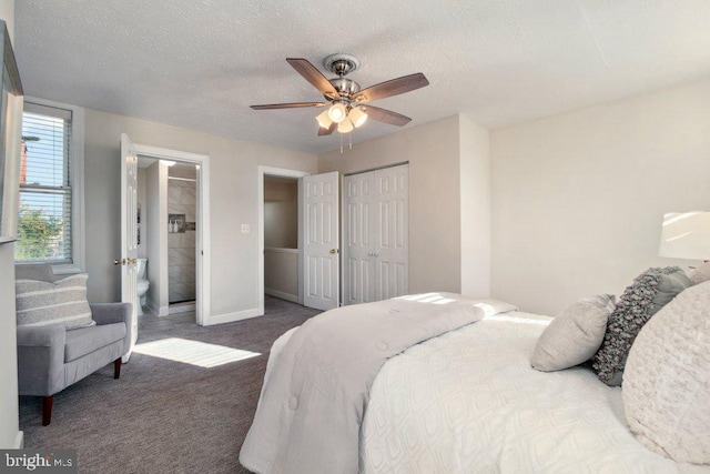 bedroom featuring a closet, dark carpet, a ceiling fan, a textured ceiling, and baseboards