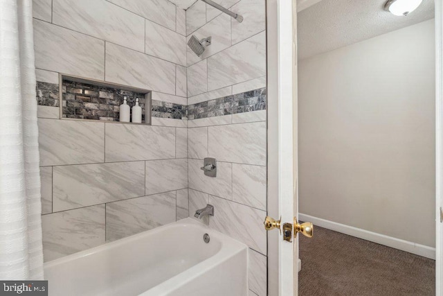 bathroom featuring shower / bathtub combination with curtain, baseboards, and a textured ceiling