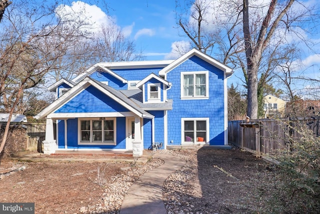 view of front of house featuring a porch and fence