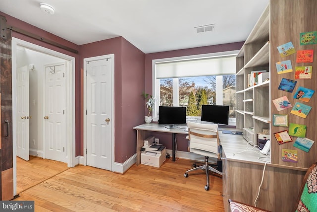 office with visible vents, baseboards, and light wood-style floors