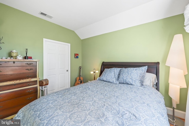 bedroom featuring visible vents and lofted ceiling