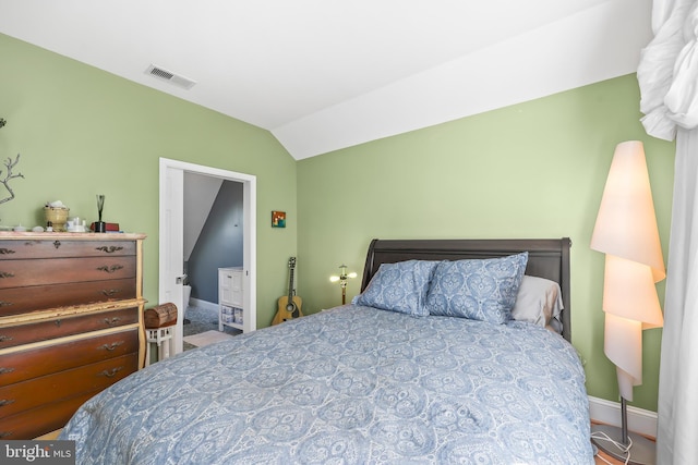 bedroom featuring visible vents, baseboards, and vaulted ceiling