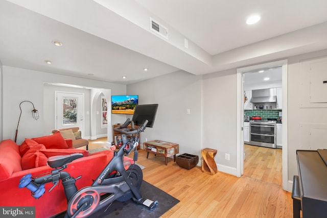 exercise area featuring light wood-type flooring, visible vents, baseboards, and recessed lighting