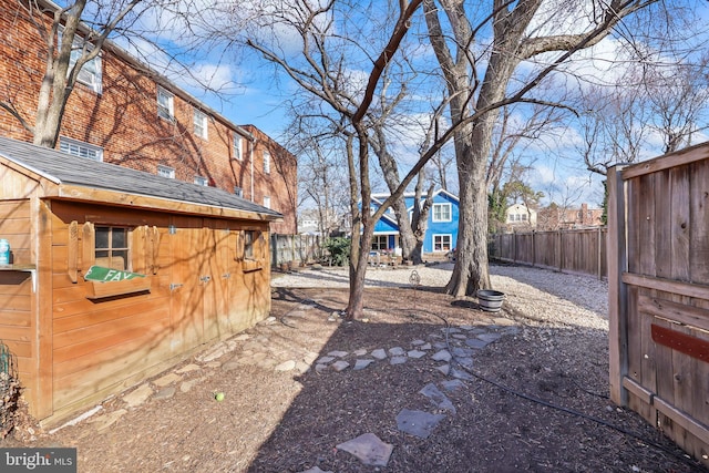 view of yard with an outdoor structure and a fenced backyard