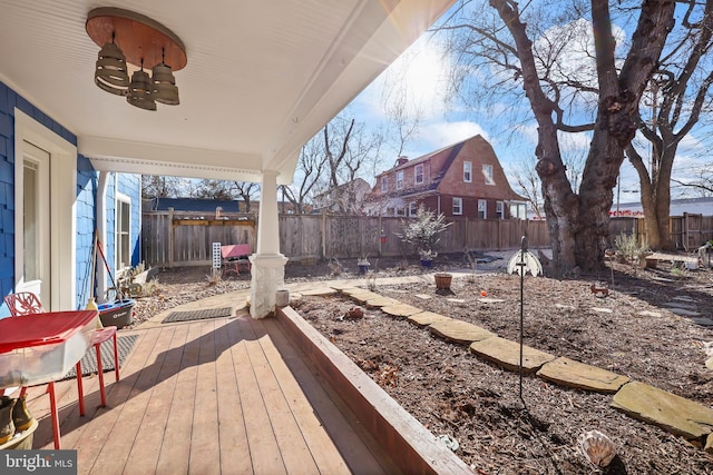 deck with a fenced backyard and a ceiling fan