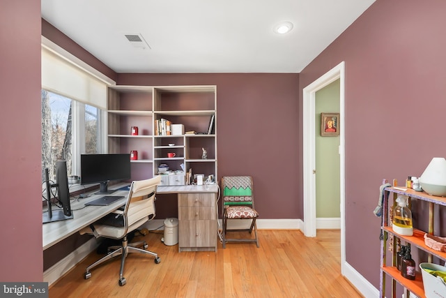 home office featuring visible vents, baseboards, and light wood finished floors