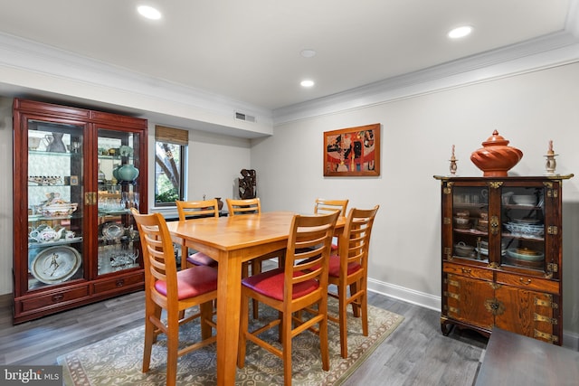 dining space with ornamental molding, recessed lighting, visible vents, and dark wood finished floors