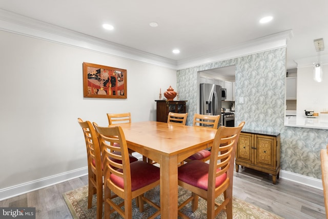 dining area with crown molding, recessed lighting, wood finished floors, baseboards, and wallpapered walls