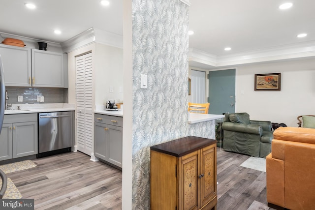 kitchen featuring gray cabinetry, open floor plan, light countertops, ornamental molding, and dishwasher