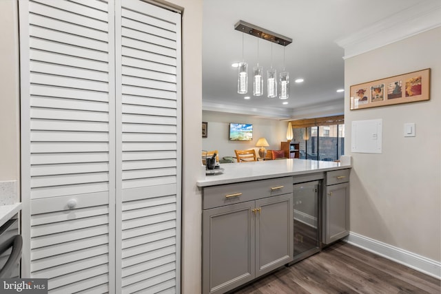 kitchen featuring wine cooler, light countertops, gray cabinetry, ornamental molding, and open floor plan