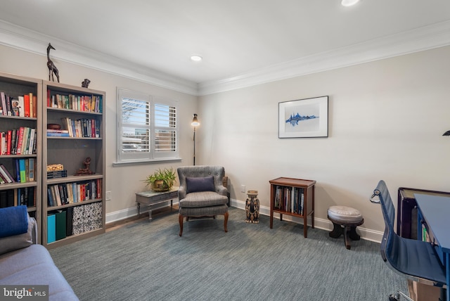 sitting room featuring baseboards, dark colored carpet, and crown molding