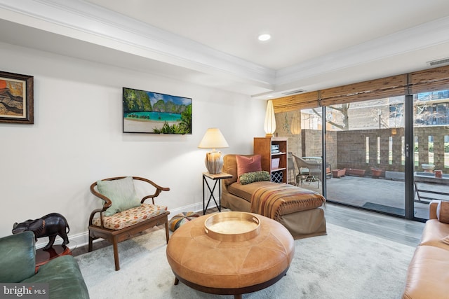 sitting room with visible vents, crown molding, baseboards, and wood finished floors