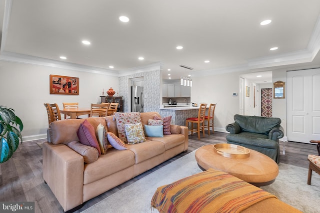 living area featuring wood finished floors, crown molding, and recessed lighting