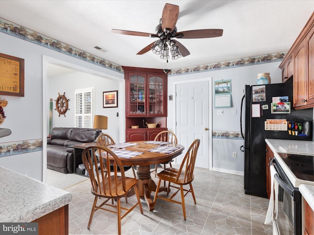 dining area with visible vents, ceiling fan, a textured ceiling, and baseboards