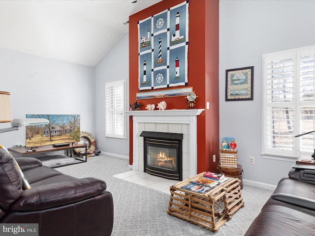 living area with vaulted ceiling, a fireplace, light carpet, and baseboards