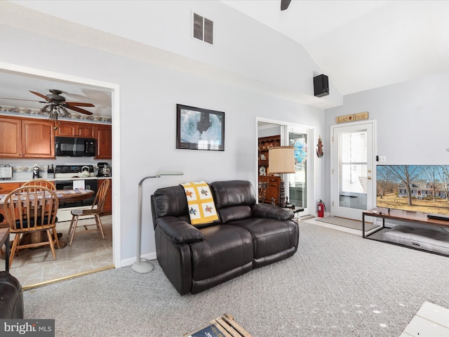 living area featuring visible vents, a ceiling fan, light carpet, vaulted ceiling, and baseboards