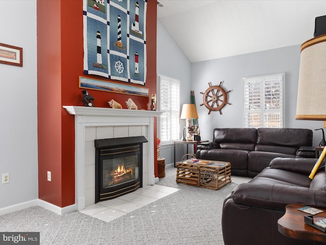 living area featuring lofted ceiling, light colored carpet, a fireplace, and baseboards