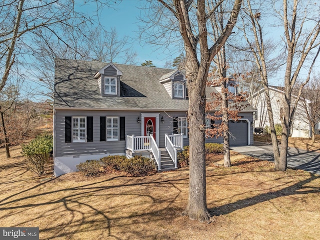 new england style home featuring roof with shingles, concrete driveway, a front yard, crawl space, and a garage