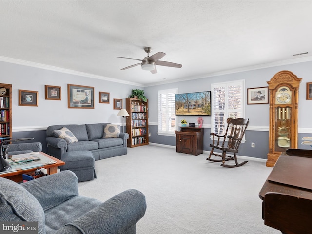 living room with baseboards, light colored carpet, visible vents, and crown molding