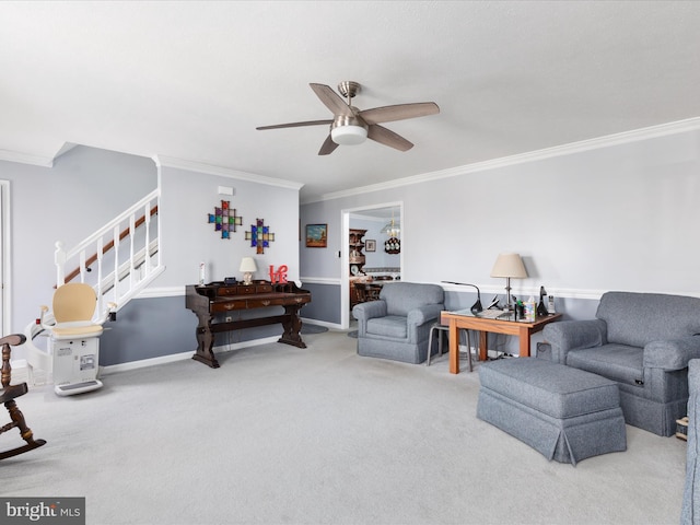 carpeted living area with baseboards, ceiling fan, stairway, and crown molding