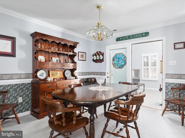 dining room featuring light colored carpet, crown molding, wallpapered walls, and an inviting chandelier