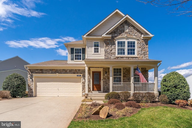 view of front facade featuring an attached garage, stone siding, driveway, and a porch