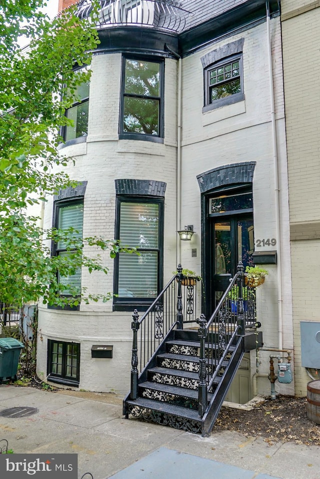 entrance to property featuring brick siding