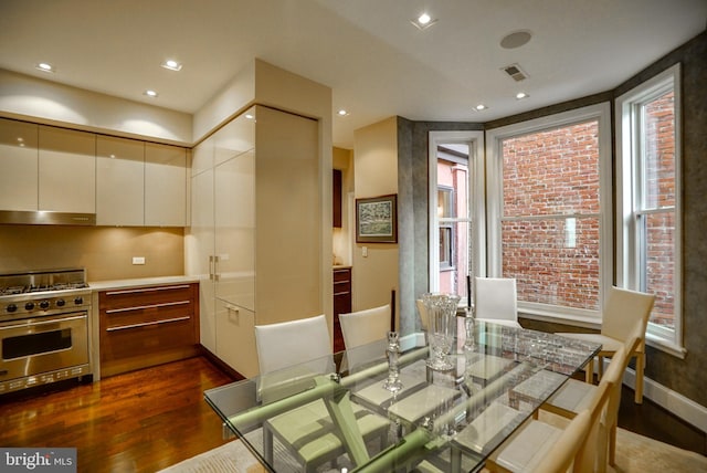 dining space featuring dark wood finished floors, recessed lighting, and visible vents