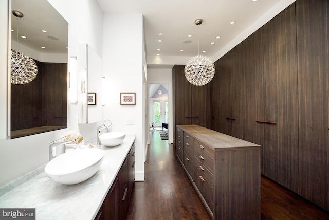 full bathroom featuring a sink, recessed lighting, wood finished floors, and double vanity