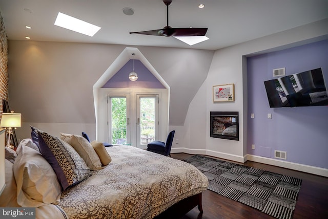 bedroom featuring visible vents, wood finished floors, baseboards, and access to exterior