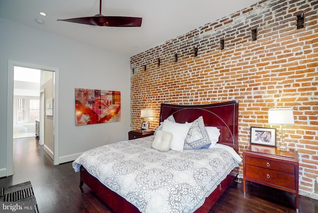 bedroom featuring wood finished floors, baseboards, brick wall, and ceiling fan