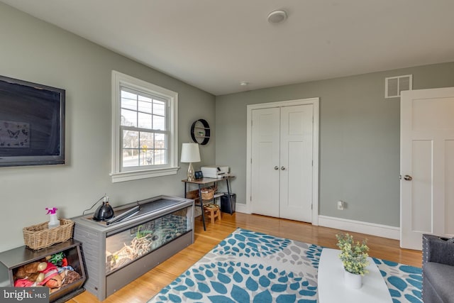 interior space with light wood finished floors, visible vents, and baseboards