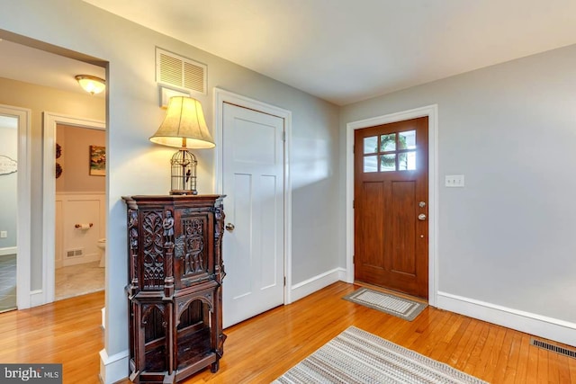 entrance foyer featuring light wood-style floors, visible vents, and baseboards