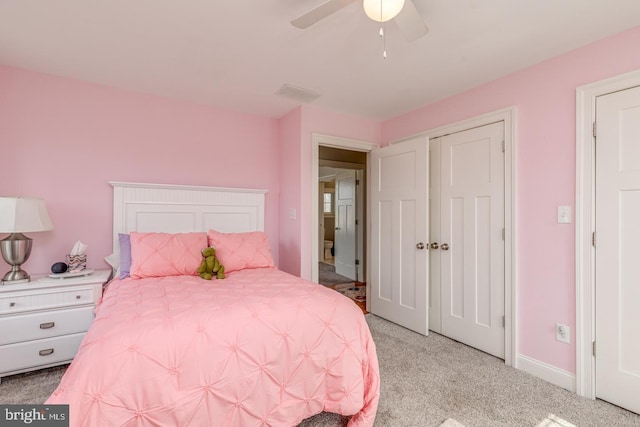 bedroom featuring light colored carpet, ceiling fan, visible vents, and baseboards