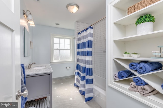 full bath with shower / bathtub combination with curtain, vanity, and baseboards