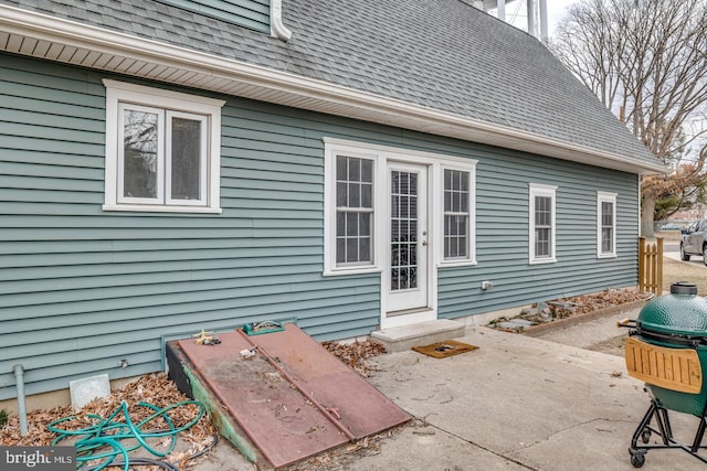 exterior space featuring entry steps and roof with shingles