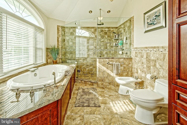 full bath featuring lofted ceiling, a shower stall, toilet, and tile walls