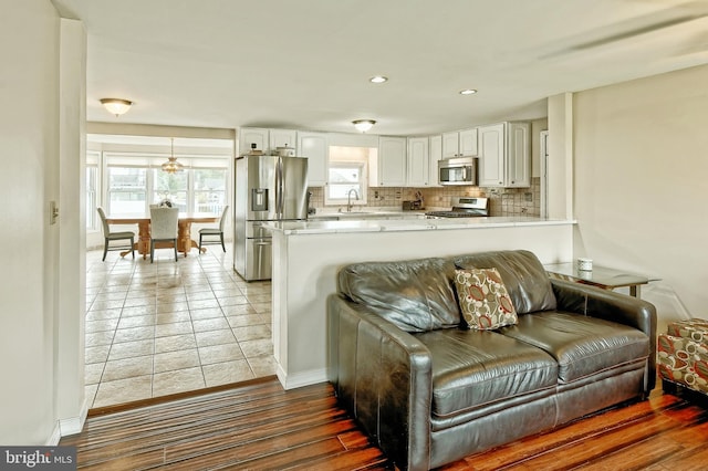 living room with recessed lighting and baseboards