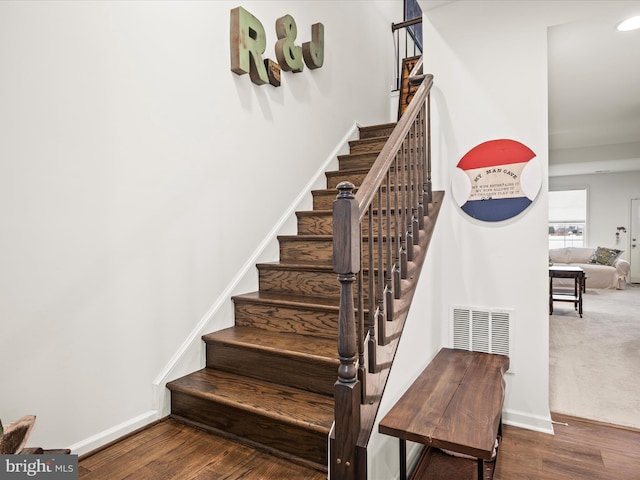 stairway with recessed lighting, baseboards, and wood finished floors