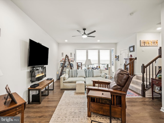 living area featuring a ceiling fan, dark wood-type flooring, stairway, and recessed lighting