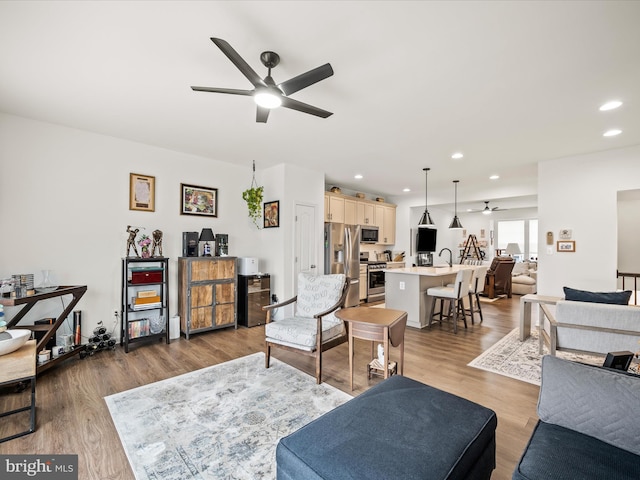 living room featuring recessed lighting, wood finished floors, and ceiling fan