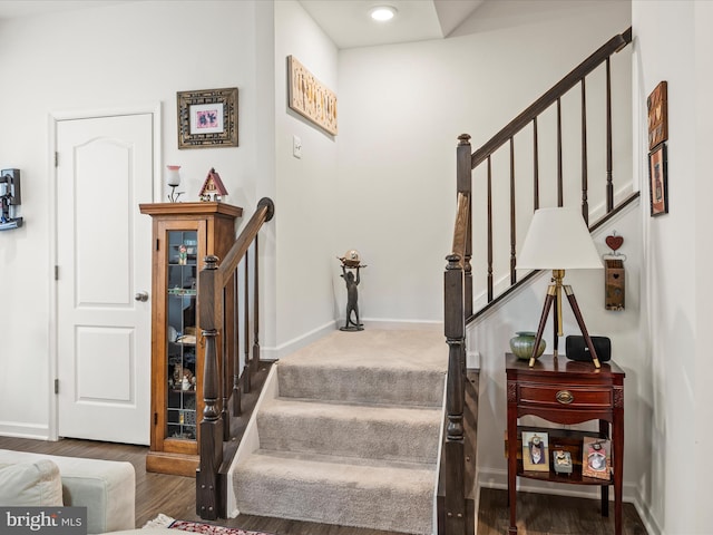 stairs with baseboards and wood finished floors