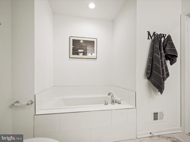 bathroom featuring a bath, visible vents, marble finish floor, and recessed lighting