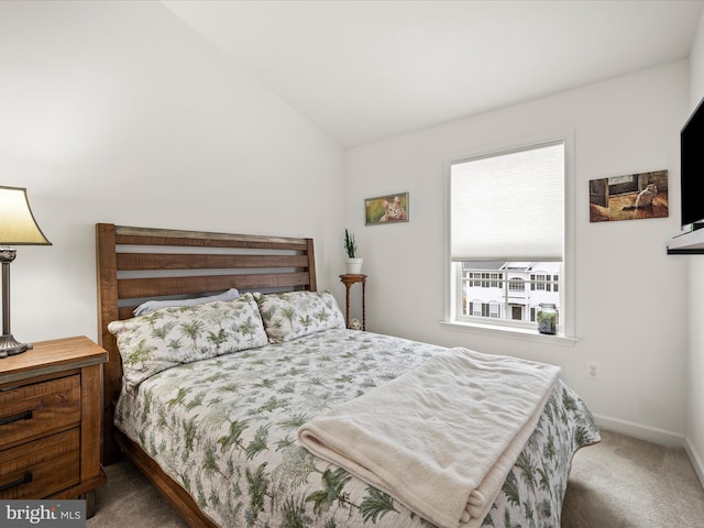 bedroom featuring baseboards, carpet, and vaulted ceiling