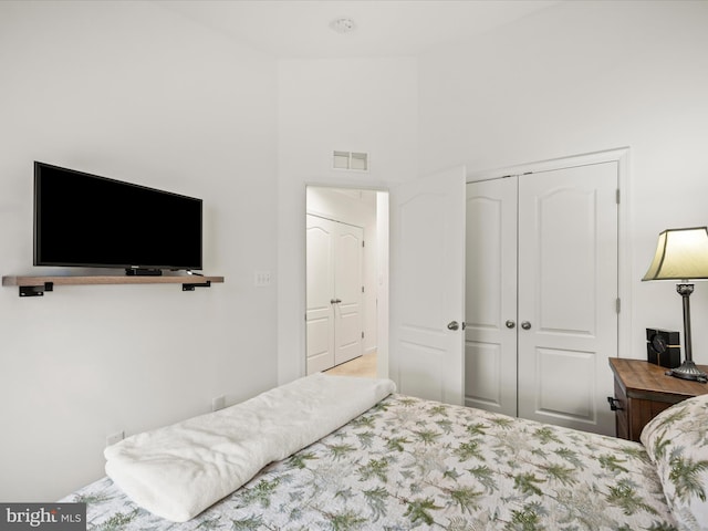 bedroom with a closet and visible vents