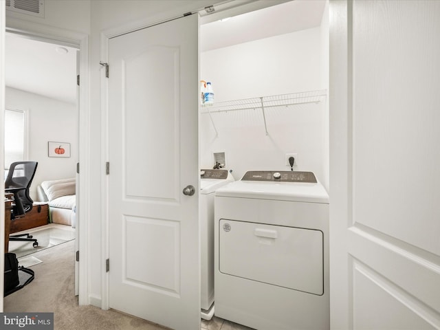 laundry area featuring light carpet, visible vents, independent washer and dryer, and laundry area