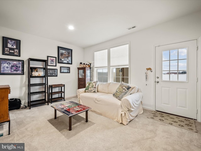 living area with recessed lighting, visible vents, carpet floors, and baseboards