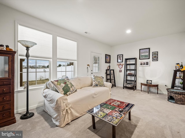 carpeted living area featuring recessed lighting and baseboards